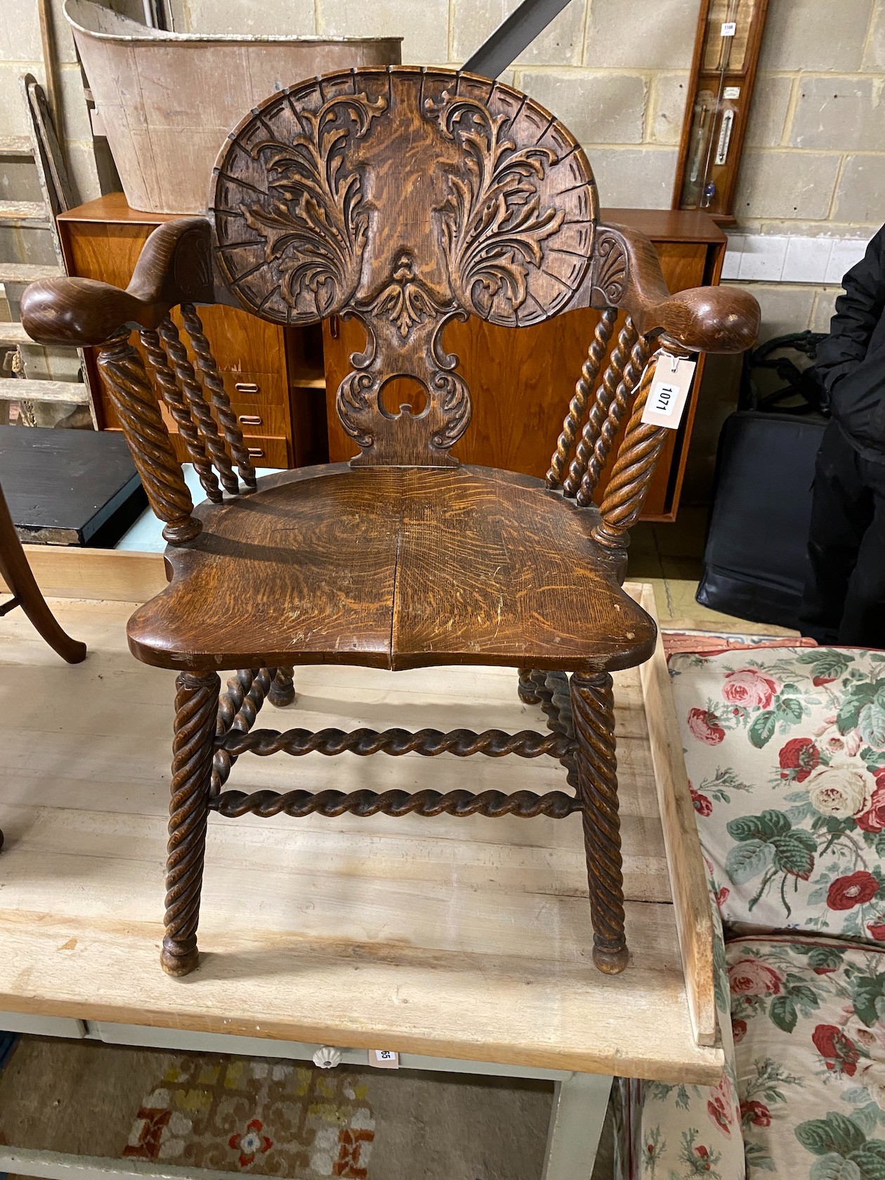 A 19th century Continental carved oak tub framed elbow chair on turned spiral underframe, width 65cm, depth 50cm, height 89cm